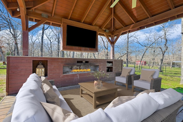 view of patio featuring an outdoor living space with a fireplace and a gazebo