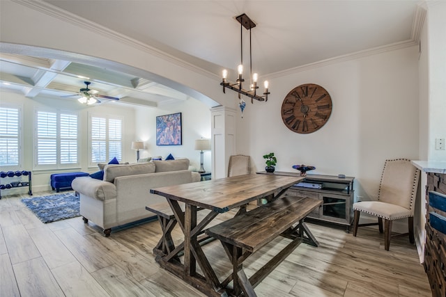 dining area with coffered ceiling, ceiling fan with notable chandelier, beamed ceiling, light hardwood / wood-style floors, and ornamental molding