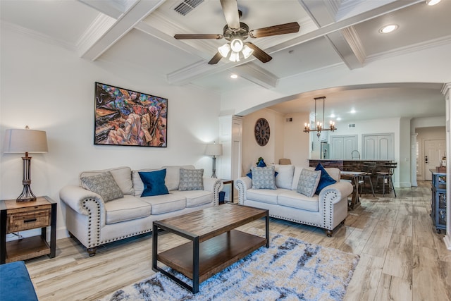 living room featuring light hardwood / wood-style flooring, ornamental molding, ceiling fan with notable chandelier, and beam ceiling