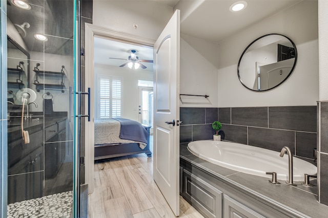 bathroom with hardwood / wood-style floors, independent shower and bath, and ceiling fan