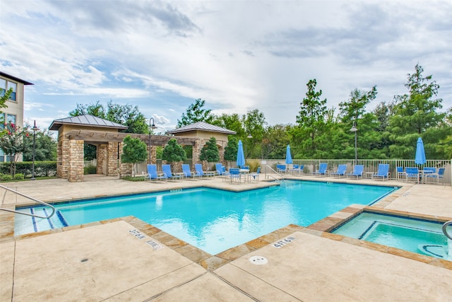 view of swimming pool featuring a community hot tub and a patio area