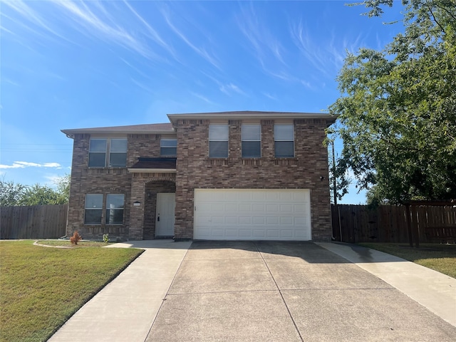 view of front of property with a front yard and a garage