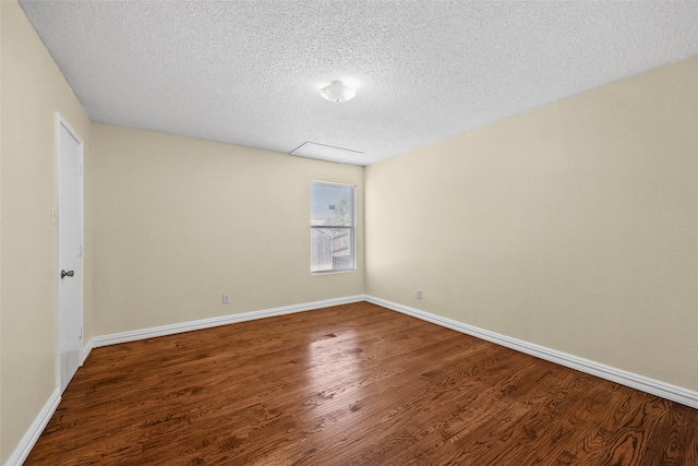 unfurnished room featuring wood-type flooring and a textured ceiling