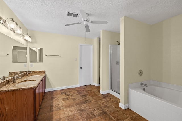 bathroom with vanity, ceiling fan, independent shower and bath, and a textured ceiling