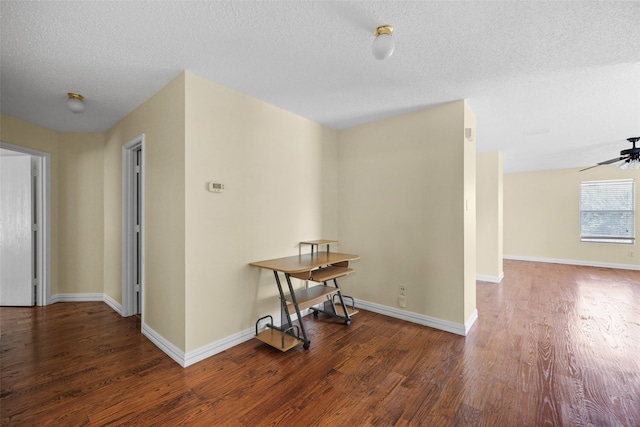 hall with dark hardwood / wood-style floors and a textured ceiling