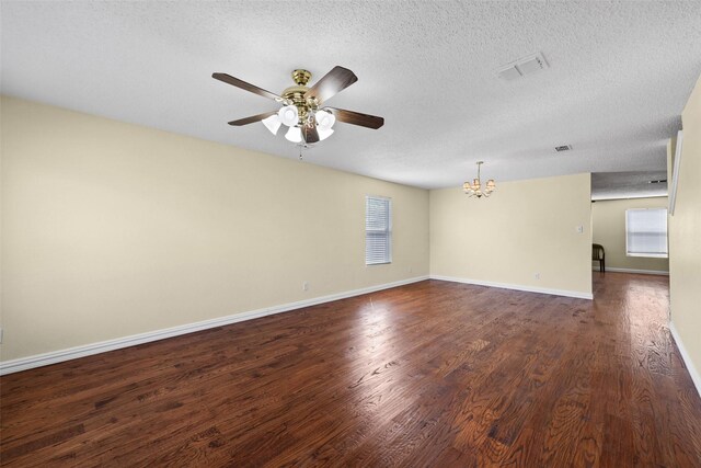 unfurnished living room with a textured ceiling, a fireplace, dark hardwood / wood-style flooring, and ceiling fan