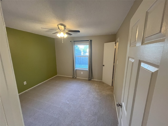 unfurnished room featuring light carpet, ceiling fan, and a textured ceiling