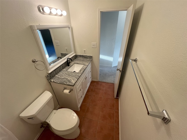 bathroom with tile patterned floors, vanity, and toilet