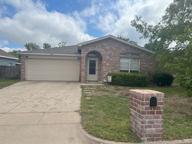 ranch-style home with a front yard and a garage