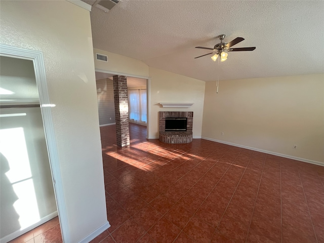 unfurnished living room featuring dark tile patterned flooring, a textured ceiling, vaulted ceiling, a brick fireplace, and ceiling fan