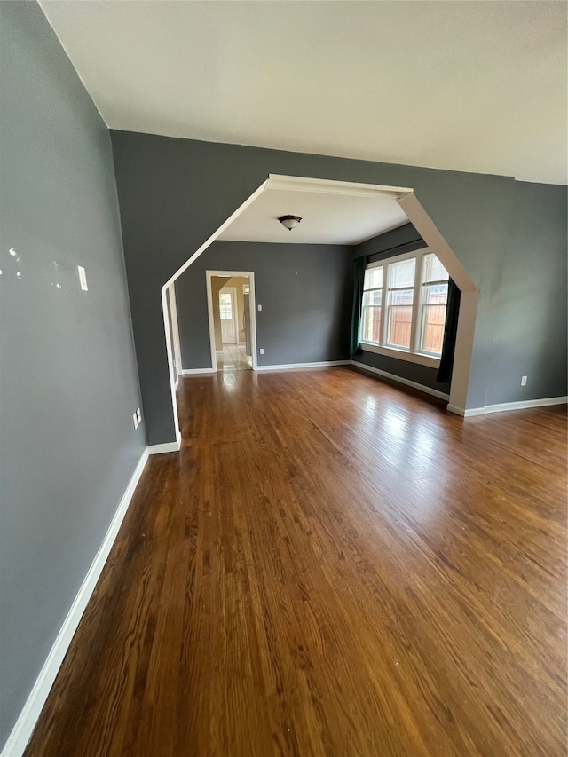 spare room with dark wood-type flooring