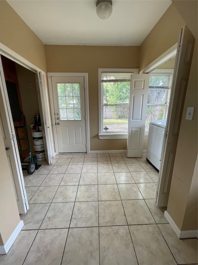 entryway featuring washer / clothes dryer and light tile patterned floors