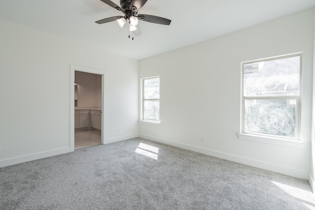 unfurnished bedroom with carpet flooring, ceiling fan, a spacious closet, and a closet