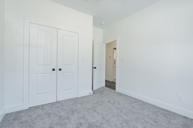 unfurnished bedroom featuring a closet and carpet floors