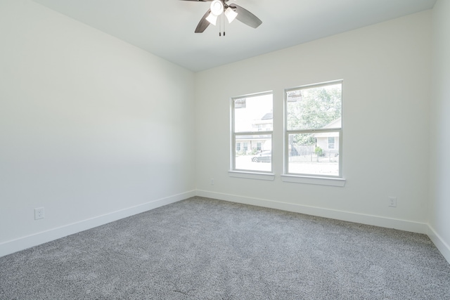 unfurnished room with ceiling fan and carpet floors