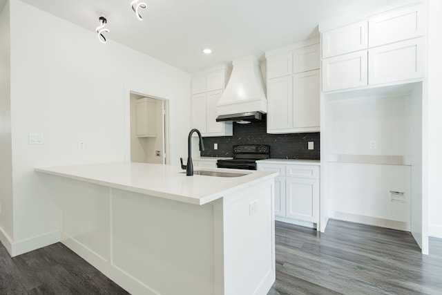 kitchen with backsplash, dark hardwood / wood-style flooring, white cabinetry, premium range hood, and black range with electric cooktop