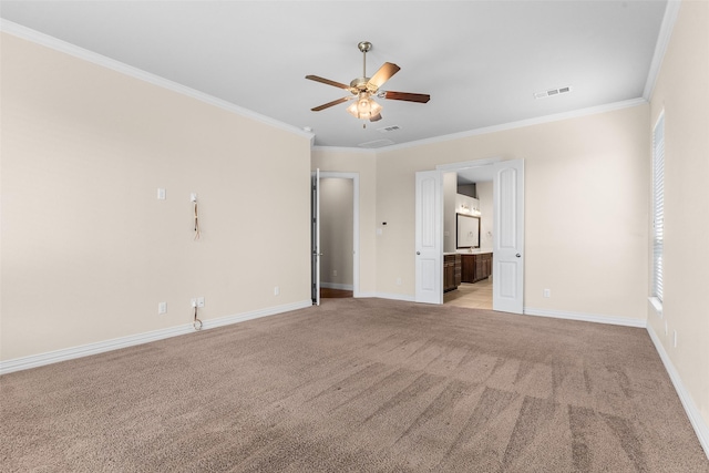 interior space featuring ornamental molding, baseboards, visible vents, and light carpet