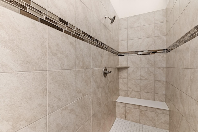 bathroom with a tile shower