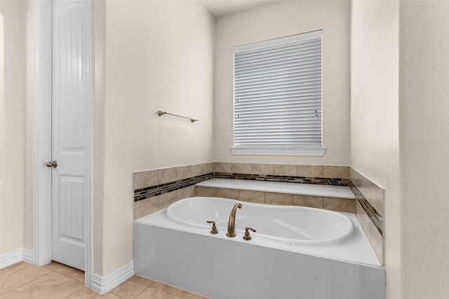 bathroom with tile patterned floors and a bath