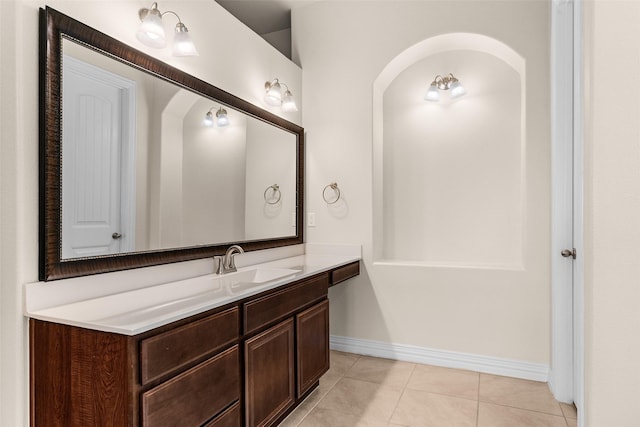 bathroom featuring tile patterned flooring, vanity, and baseboards