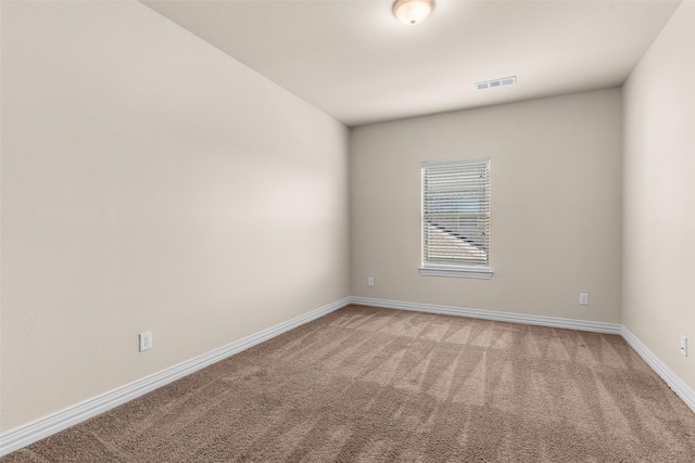 unfurnished room featuring visible vents, baseboards, and light colored carpet