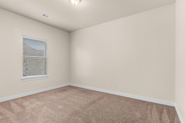 unfurnished room with baseboards, visible vents, and carpet floors