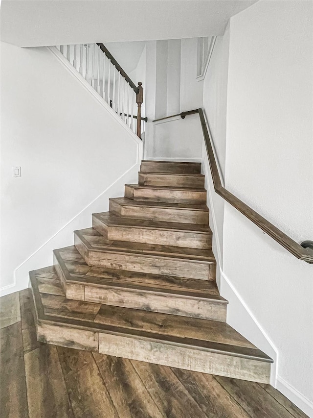 stairs with hardwood / wood-style floors