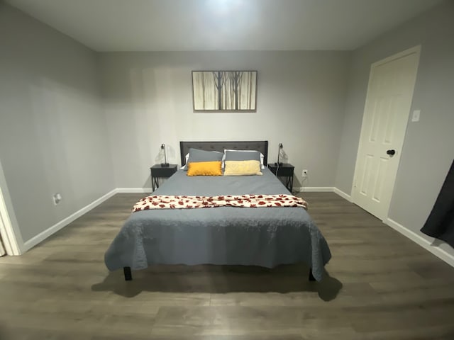 bedroom with dark wood-type flooring