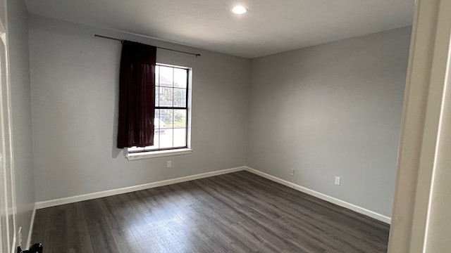 unfurnished room featuring dark wood-type flooring