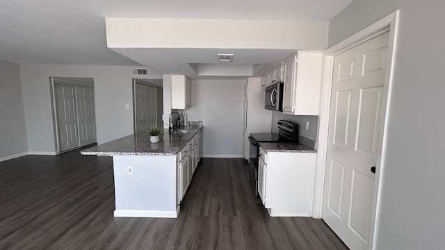 kitchen with dark stone countertops, white cabinetry, dark hardwood / wood-style flooring, sink, and black range with electric stovetop