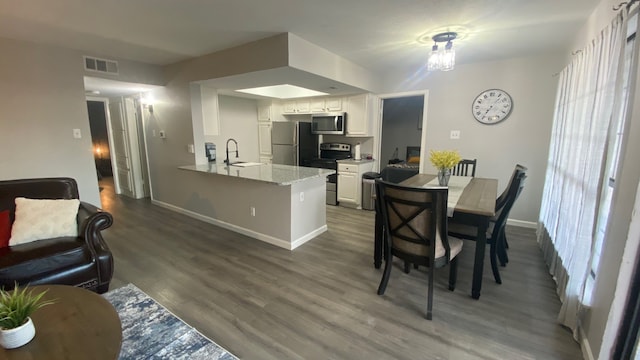 dining area featuring hardwood / wood-style flooring and sink