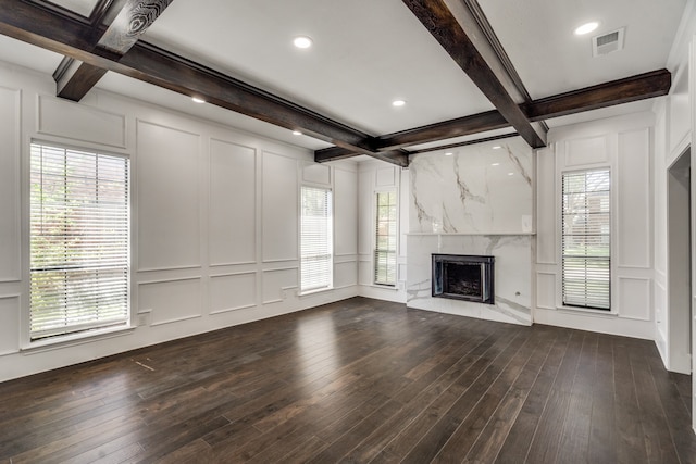 unfurnished living room with a high end fireplace, dark hardwood / wood-style flooring, and a wealth of natural light