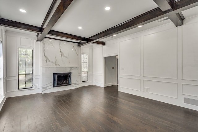 unfurnished living room with coffered ceiling, a premium fireplace, dark hardwood / wood-style flooring, and beam ceiling