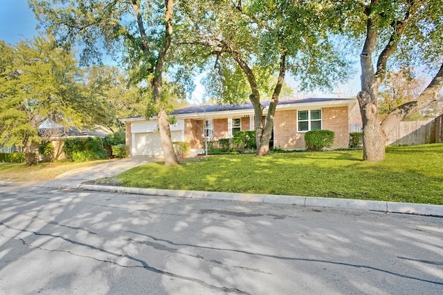 ranch-style house with a garage and a front yard