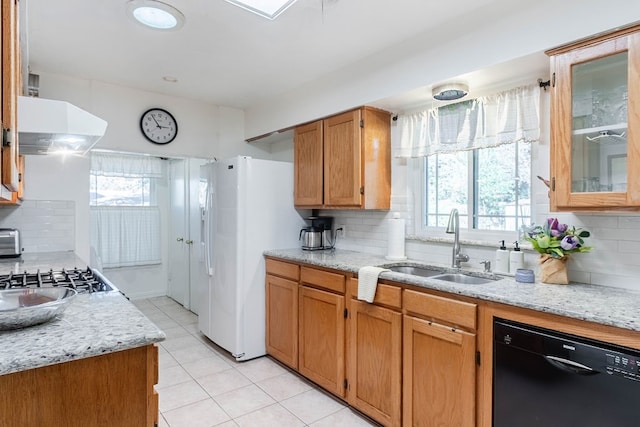 kitchen with dishwasher, backsplash, sink, and range hood