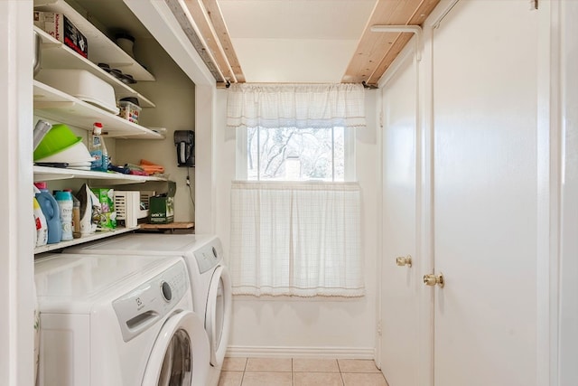 clothes washing area featuring separate washer and dryer and light tile patterned floors