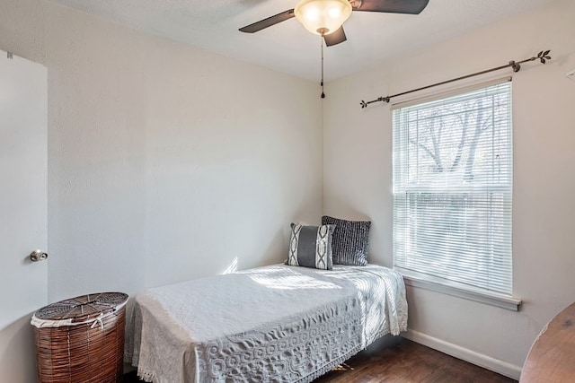 bedroom with ceiling fan and dark hardwood / wood-style flooring