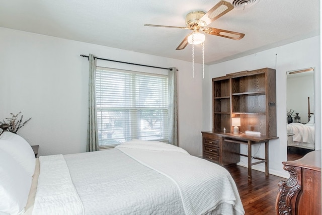 bedroom with ceiling fan and dark hardwood / wood-style floors