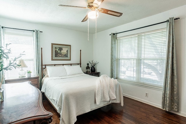 bedroom featuring a textured ceiling, dark wood-type flooring, and ceiling fan