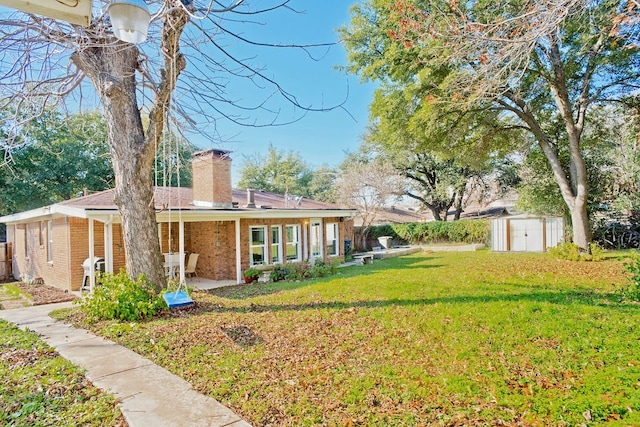 exterior space with a front lawn, a shed, and a patio