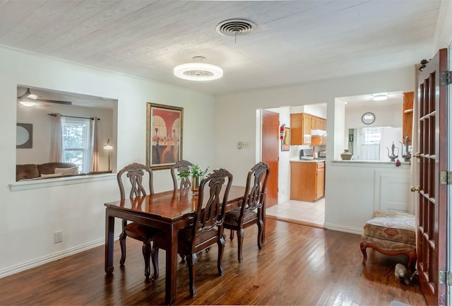 dining area with light wood-type flooring and ceiling fan