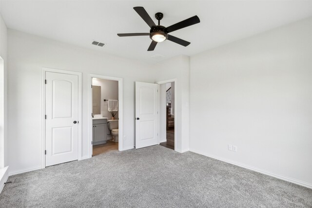 unfurnished bedroom featuring carpet flooring, ceiling fan, and ensuite bathroom