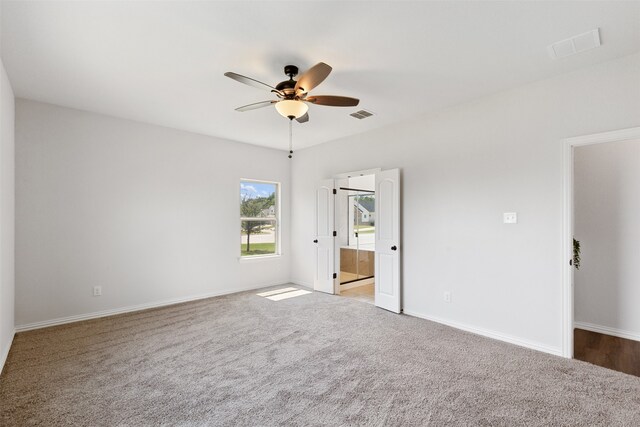 unfurnished bedroom featuring ceiling fan and light colored carpet