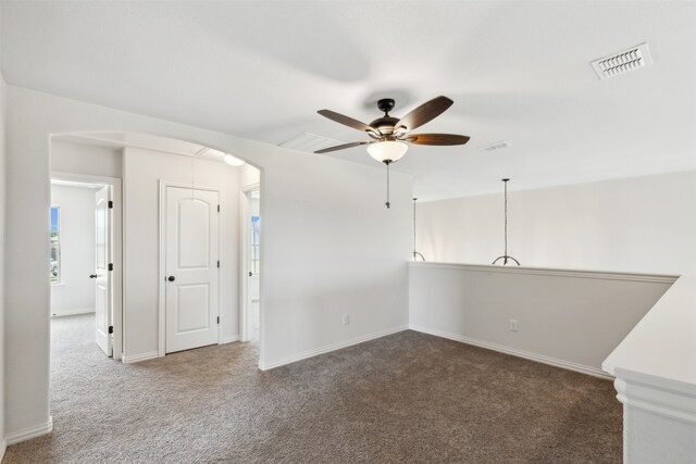 carpeted empty room featuring ceiling fan