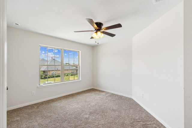 spare room featuring carpet flooring and ceiling fan