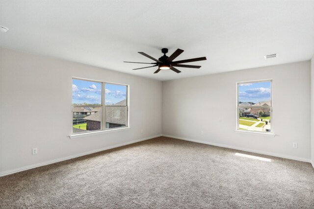 spare room featuring ceiling fan and carpet floors