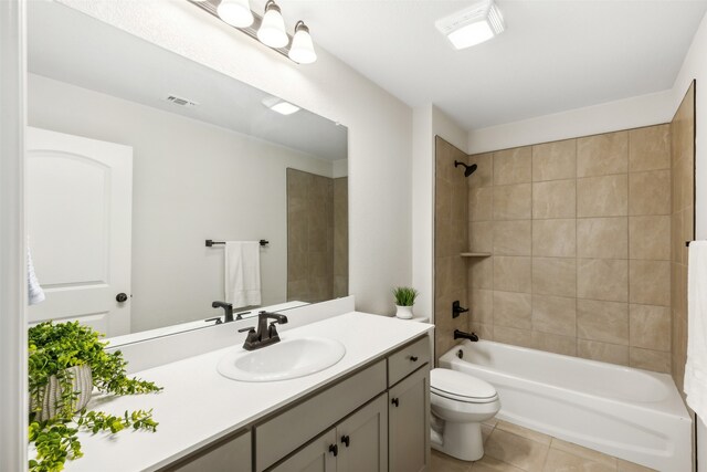 full bathroom with tile patterned flooring, vanity, toilet, and tiled shower / bath combo