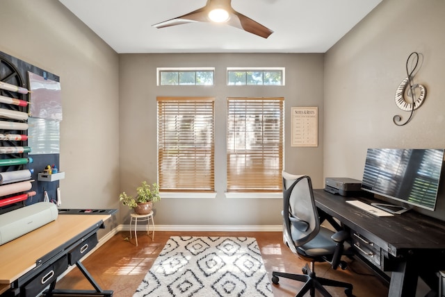 tiled home office featuring ceiling fan