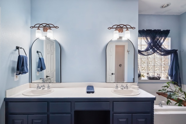 bathroom with vanity and a bathtub