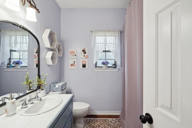 bathroom featuring tile patterned floors, vanity, and toilet